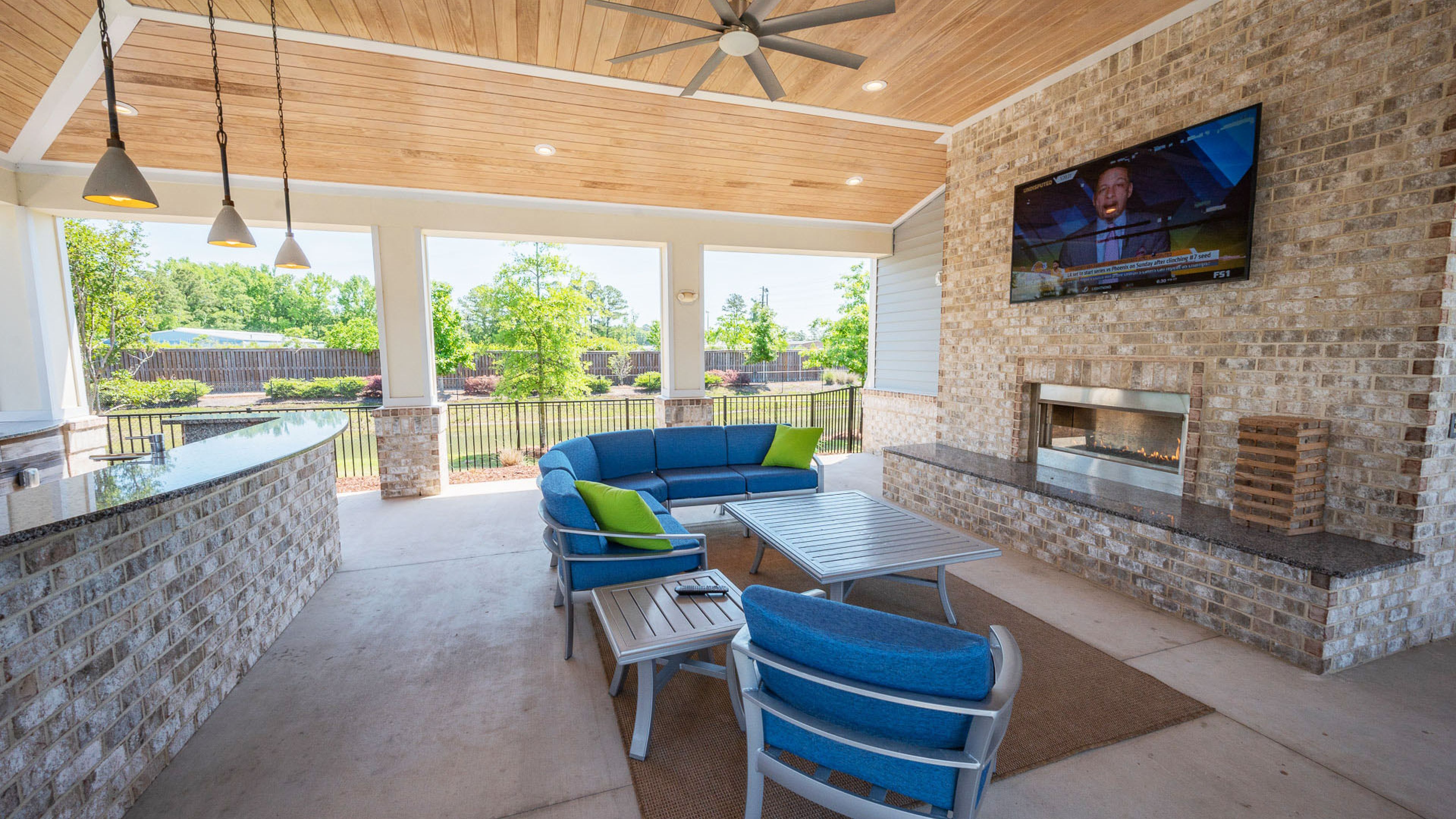 Hawthorne at Leland outdoor amenity lounge area with fireplace and entertainment space with kitchen