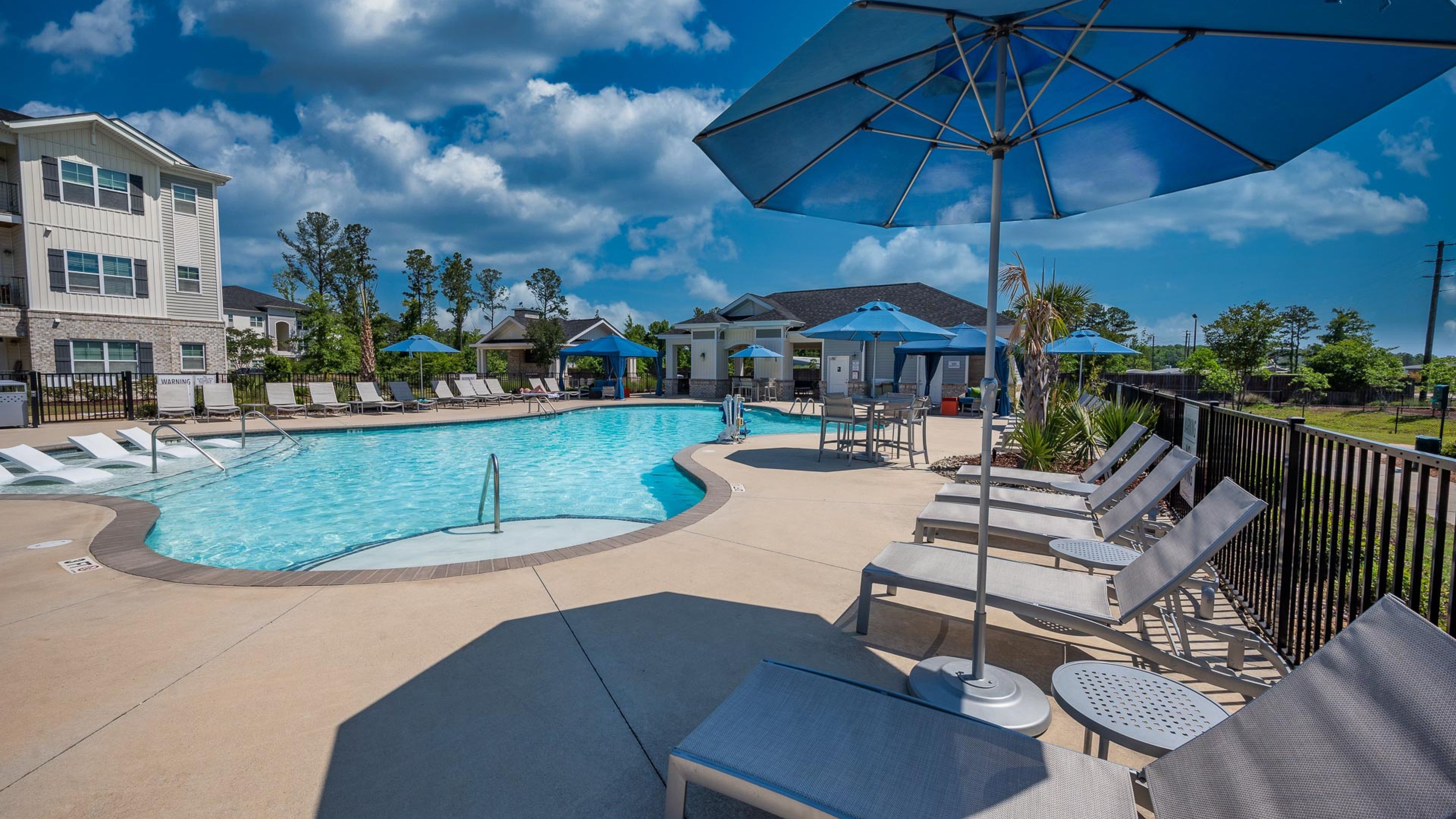 Hawthorne at Leland community amenities exterior of pool with lounge seating