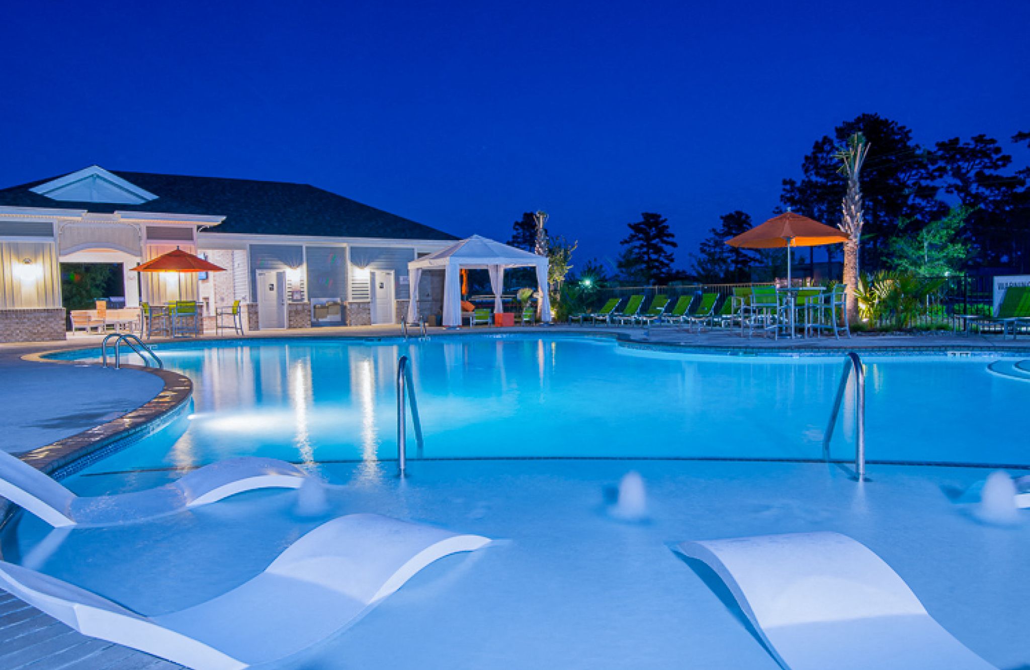 Hawthorne at Leland luxury outdoor pool with in-pool lounge chairs and surrounding seating